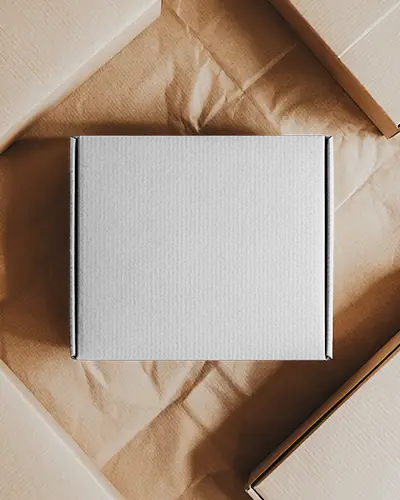 top-view-box-mockup-amidst-paper-packaging-flatlay-scene-rustic-natural-corrugated-material