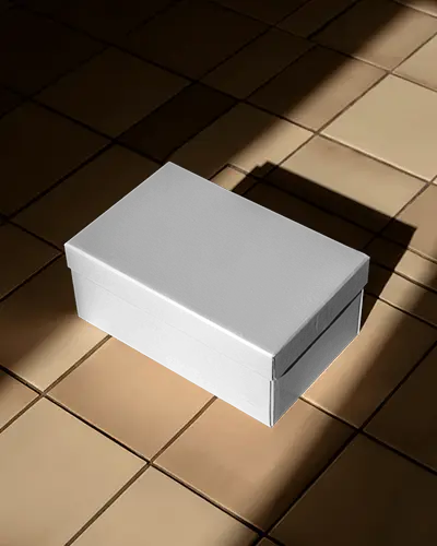 luxury-shoebox-mockup-on-tiled-floor-with-dramatic-sunlight-shadows-stylish-display