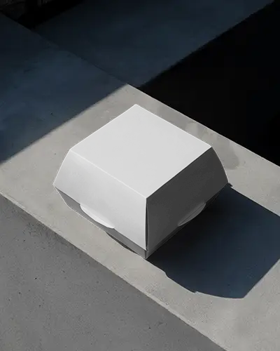 matte-burger-box-mockup-on-concrete-surface-with-dark-shadows-urban-modern-presentation