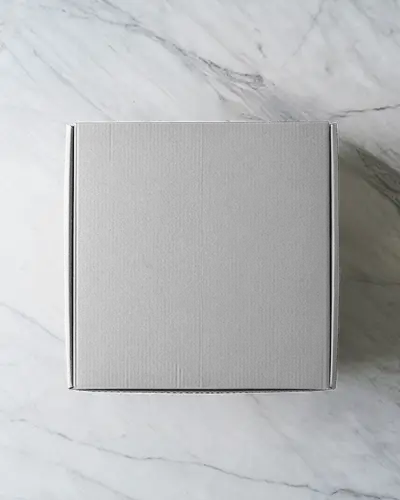 Top View Square Cardboard Box Mockup On Marble Background With Clean Elegant Lighting Style