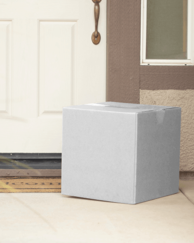 Plain Cardboard Box Mockup Lying Outsied Room In Front Of Door