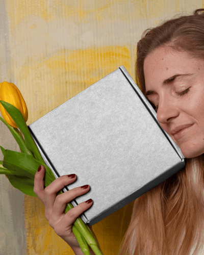 Woman Holding Box Mockup And Flower In One Hand