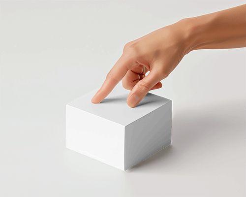 Cubical Cardboard Box Mockup With Finger Pointing On Top Of It