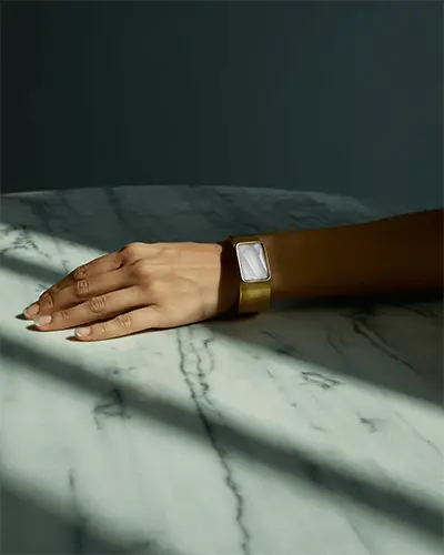 Moody Gold Bracelet Mockup On Hand Resting On Marble Surface With Dramatic Shadows