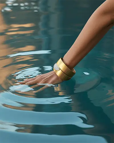 Gold Statement Bracelet Mockup On Hand Gliding Through Water With Luxury Summer Vibe