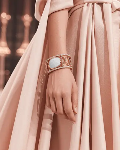Elegant Rose Gold Bracelet Mockup On Wrist With Flowing Peach Gown Details
