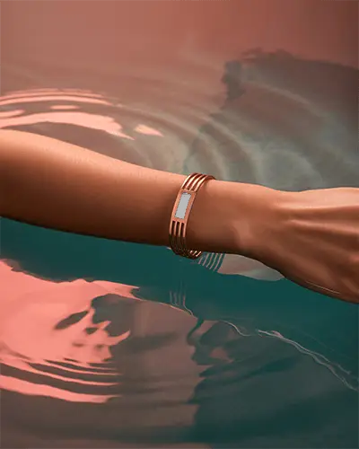 Rose Gold Bracelet Mockup On Wrist Above Water With Soft Pink Reflections
