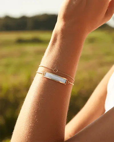 Sunlit Gold Bracelet Mockup On Wrist In Bright Outdoor Field Setting In Warm Natural Sunlight