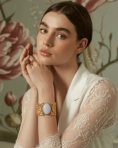 Elegant Gold Bracelet Mockup On Model With Floral Art Backdrop