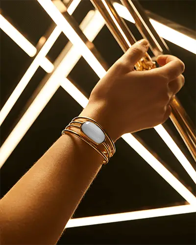 Radiant Gold Bracelet Mockup Against Geometric Light Beams In Modern Studio