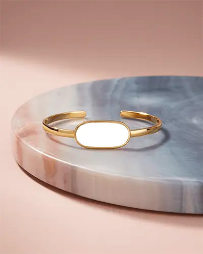 Elegant Gold Cuff Bracelet Mockup With Oval Plate On Marble Display In Soft Pink Lighting