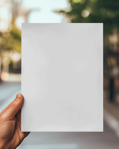 Hand Presenting Brochure Mockup With Blurry Street Scenery