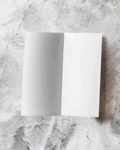 Brochure Mockup With Marble Backdrop And Design On Spread Pages