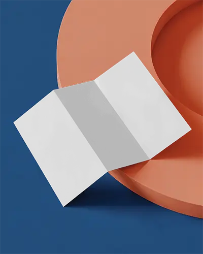 Square Brochure Mockup On Wooden Table With Pen Top View Scene Warm And Classic