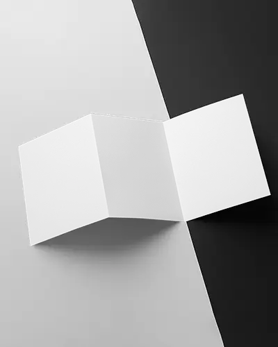 Dynamic Trifold Brochure Mockup Floating Over Half Black Half White Background Bold Studio Shot