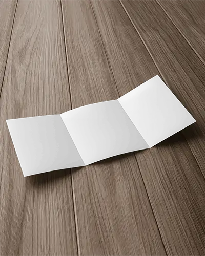 Tri Fold Brochure Mockup Top View On Wooden Flooring With Soft Lighting And Natural Grain Detail