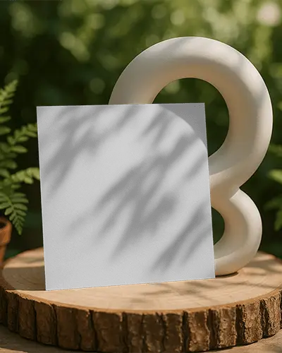 Outdoor Sunlight Square Brochure Mockup On Wooden Slice With Modern Sculpture Natural Lighting And Leafy Backdrop