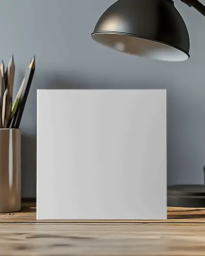 Square Brochure Mockup Standing On Wooden Desk Under Desk Lamp Modern Office Interior And Stationery Setup