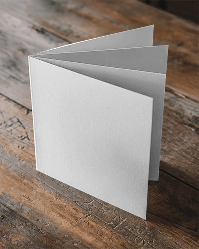 Square Brochure Mockup On Rustic Wooden Table With Natural Lighting 024