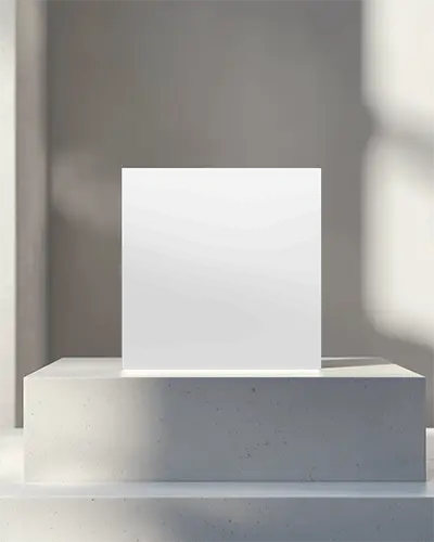 Square Brochure Mockup Standing On White Concrete Pedestal In Soft Sunlight Cozy Table Setting With Natural Shadows Minimal Elegant Holiday Presentation Scene