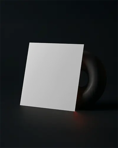 Square Brochure Mockup Leaning Against Black Smooth Sculpture On Dark Surface With Subtle Light Glow Clean Minimal Promotional Display Modern Matte Scene