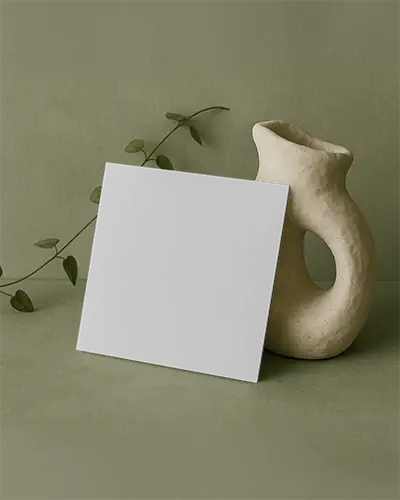 Square Brochure Mockup Against Soft Green Background With Sculptural Stand Featuring Yoga Class Promotion And Group Session Visuals For Serene Marketing