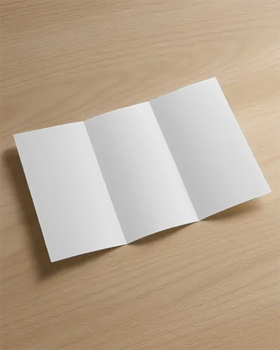 Trifold Brochure Mockup Top View On Wooden Desk Surface With Blank Panels For Custom Designs And Realistic Natural Light Presentation