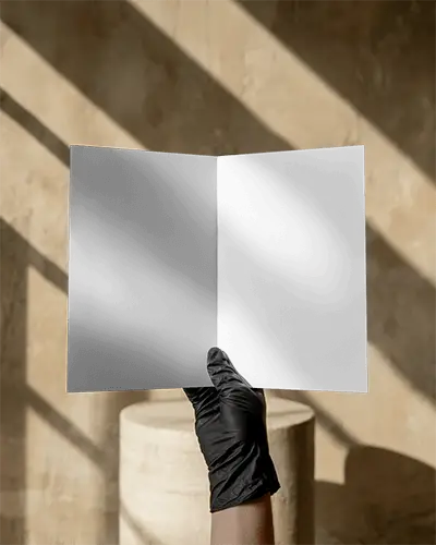 Hand Holding Open Bi Fold Brochure Mockup In Sunlit Minimal Interior With Soft Shadows And Earthy Background For Modern Presentation