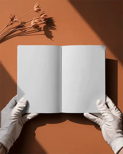Open Bifold Brochure Mockup On Orange Surface With White Gloved Hands And Dried Flower Shadow Business Layout Perspective View