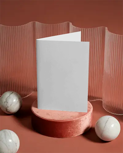 Folded Brochure Mockup On Velvet Pedestal With Marble Spheres And Textured Backdrop