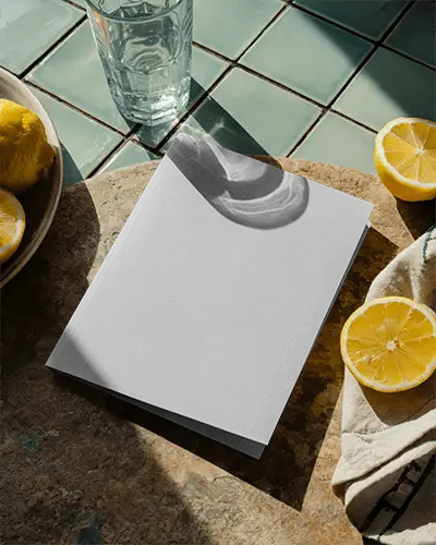 Square Brochure Mockup On Textured Stone Surface With Glass And Citrus Fruit