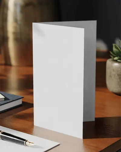 standing-brochure-mockup-on-wooden-table-with-office-accessories-for-presentation