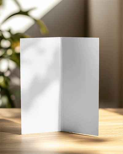 Sunlit Standing Brochure Mockup On Wooden Table With Blurred Greenery In Background 047