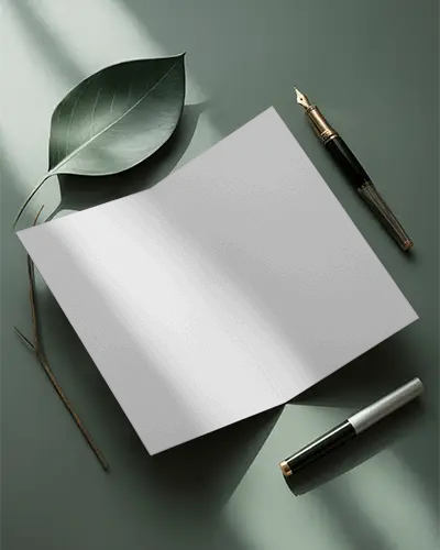 realistic-open-brochure-mockup-with-natural-leaf-and-writing-instruments-for-design-preview