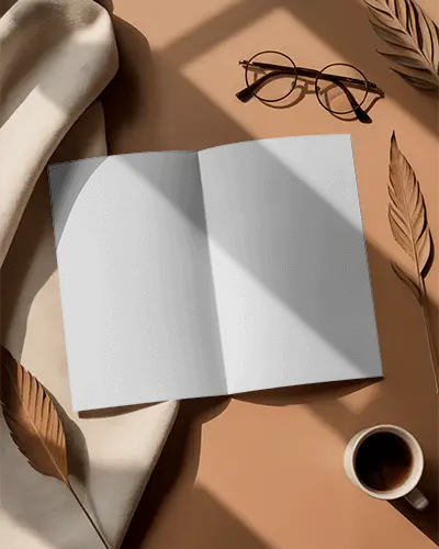 empty-open-brochure-mockup-on-table-with-natural-leaves-and-coffee-cup-props