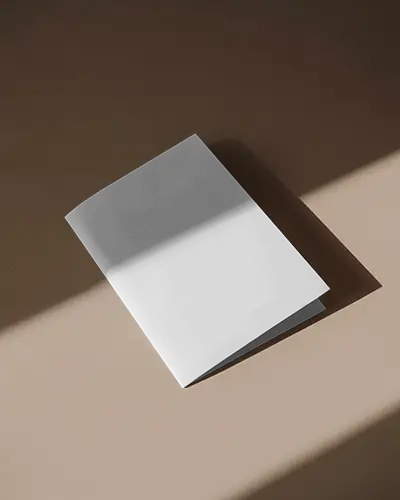 minimal-brochure-mockup-half-fold-placed-on-brown-surface-with-dramatic-light-and-shadow