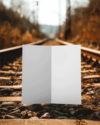 blank-two-fold-brochure-mockup-on-natural-railroad-tracks-background-for-design