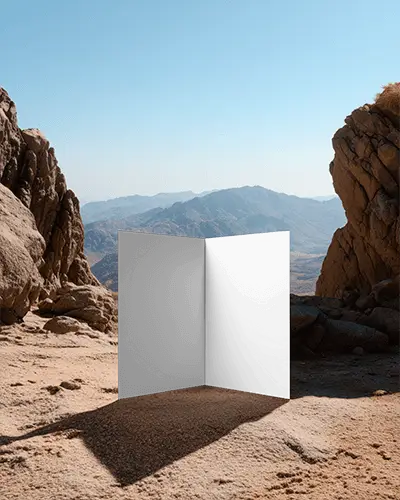 Empty Brochure Mockup Placed On Sandy Ground Between Large Rocks In Nature Scene