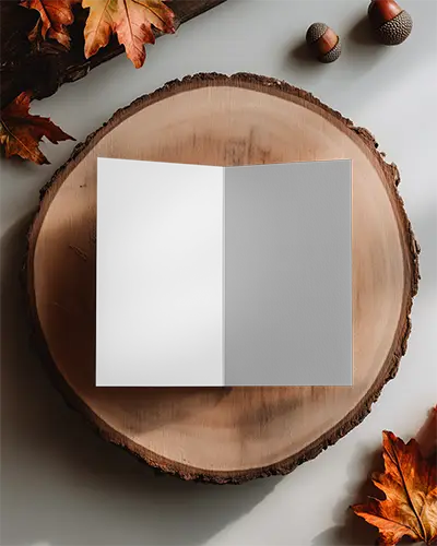 realistic-open-brochure-mockup-on-natural-wood-surface-with-acorns-and-autumn-leaves