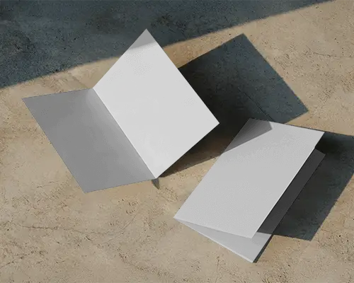 Dual Bifold Brochure Mockup On Textured Ground With Angled Light And Contemporary Style