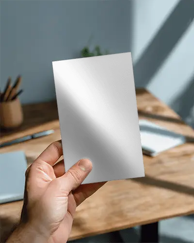 Hand Holding Minimalist Brochure Mockup Over Wooden Desk Background For Print Design