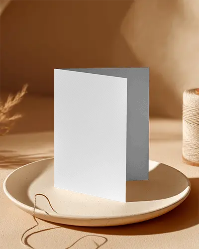Blank Folded Brochure Mockup On Ceramic Plate Ambient Light In Studio Setting