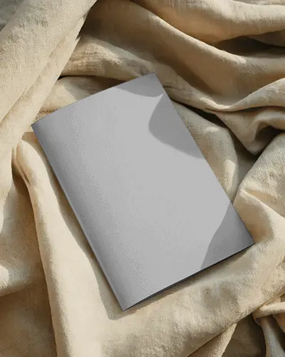 Brochure Mockup Minimal Folded Brochure Placed On Soft Fabric With Natural Light And Clean Shadows
