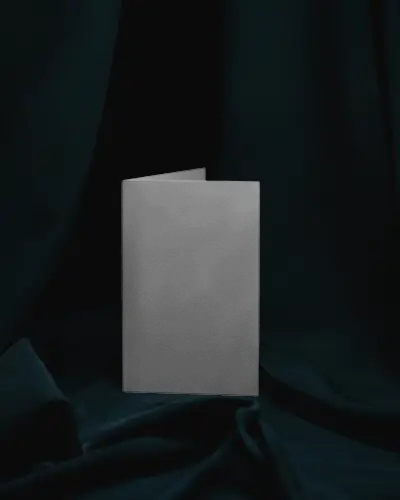 Brochure Mockup Folded Brochure Standing On Draped Fabric With Moody Low Lighting