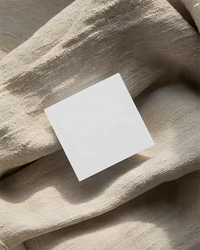premium-square-business-card-mockup-on-folded-textured-fabric-ideal-for-corporate-identity-showcase