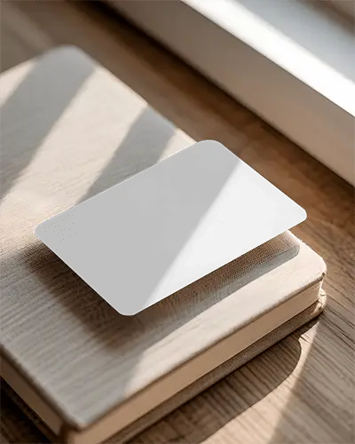 clean-rounded-corners-business-card-mockup-on-textured-book-background-in-light