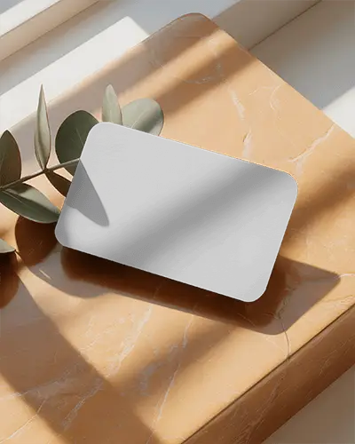 elegant-rounded-corner-business-card-mockup-on-textured-surface-with-shadow-play
