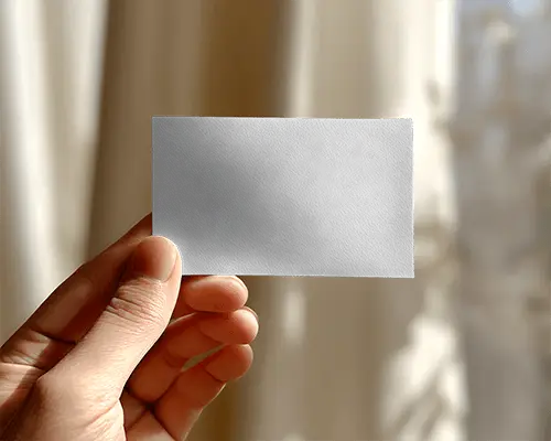 Closeup Of Hand Holding Textured Business Card Mockup With Soft Focus Background