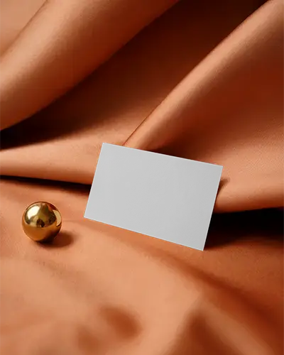 Elegant Fabric Business Card Mockup On Soft Silk Surface With Golden Sphere Decor Element
