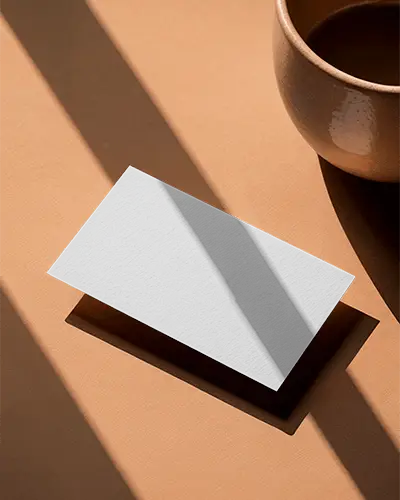 Warm Tones Horizontal Business Card Mockup On Beige Surface With Shadows And Minimal Ceramic Cup